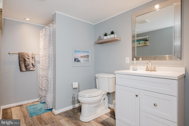 full bathroom with toilet, wood finished floors, vanity, baseboards, and crown molding