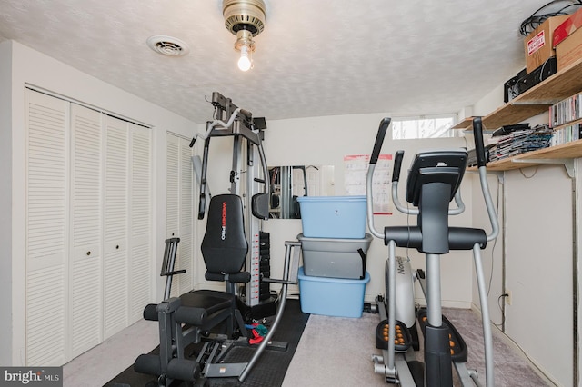 workout room with visible vents and a textured ceiling