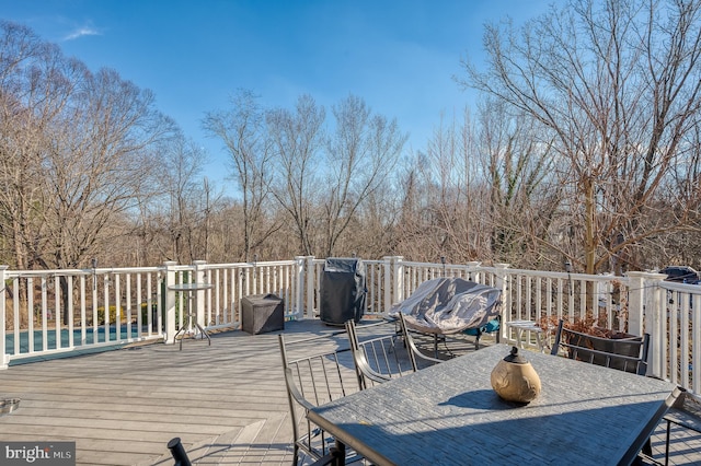 wooden deck featuring outdoor dining area