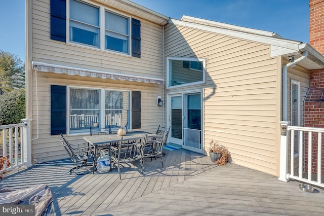 wooden deck featuring outdoor dining area