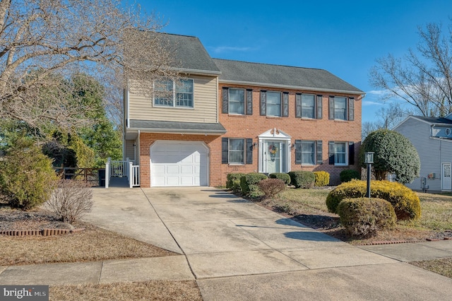 view of front of house with driveway, a garage, fence, and brick siding