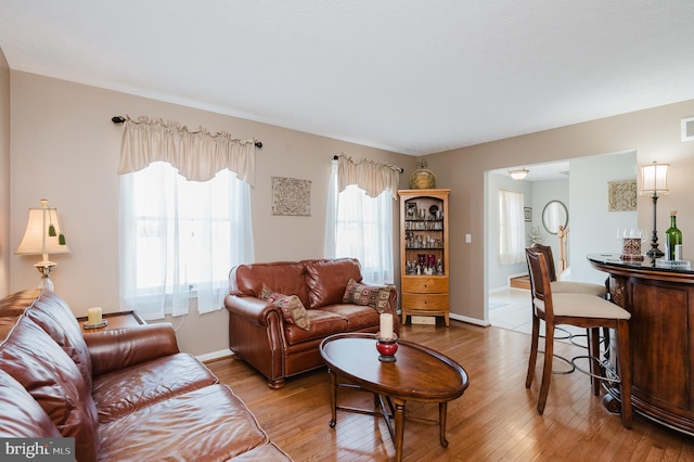 living area featuring light wood-type flooring and baseboards