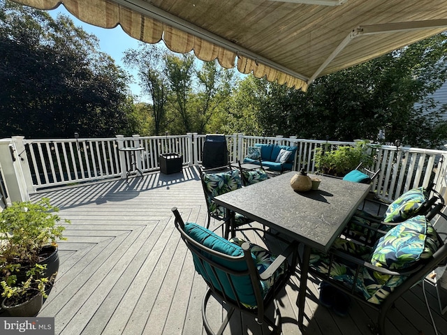 wooden terrace featuring outdoor dining space and outdoor lounge area