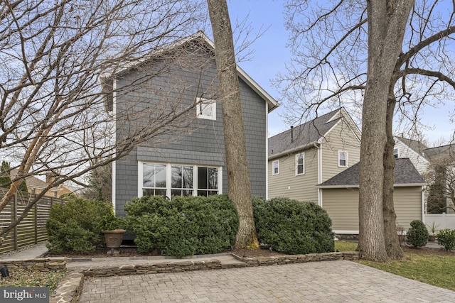 view of side of home with fence