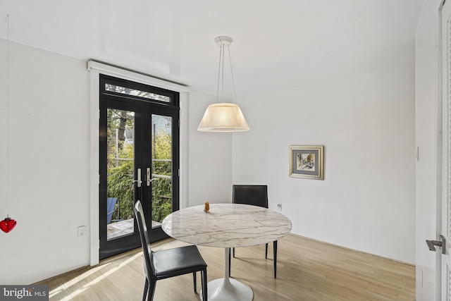 dining room with french doors and light wood finished floors