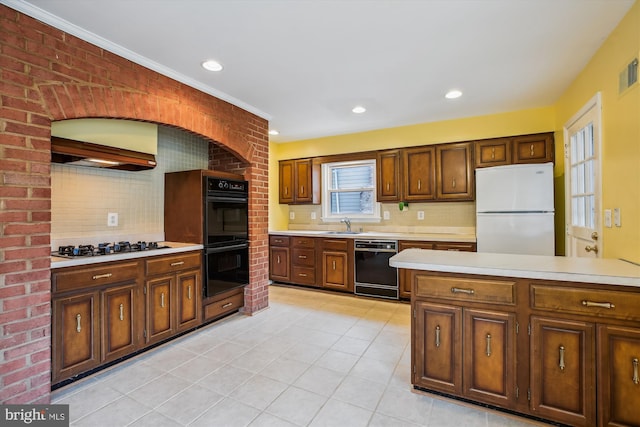 kitchen with visible vents, decorative backsplash, light countertops, black appliances, and a sink