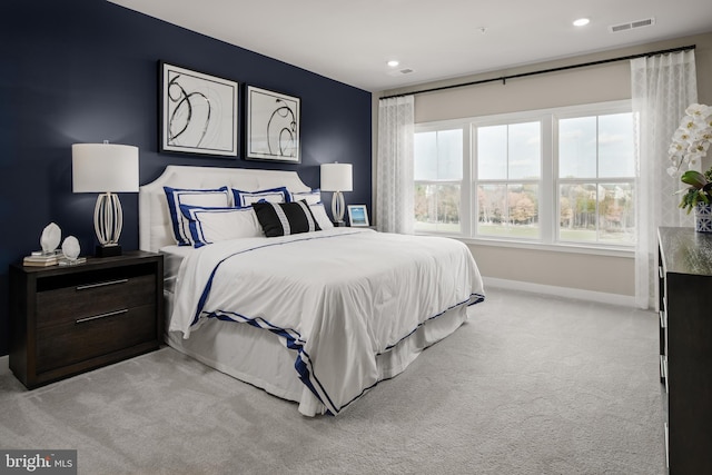 bedroom featuring baseboards, recessed lighting, visible vents, and light colored carpet