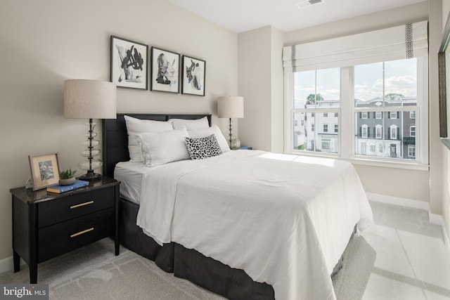 bedroom featuring light carpet, visible vents, and baseboards