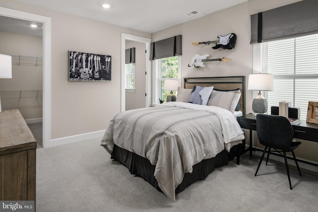 bedroom with recessed lighting, light colored carpet, visible vents, and baseboards