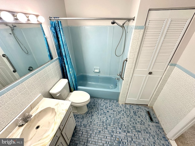 bathroom with visible vents, toilet, shower / tub combo with curtain, vanity, and tile walls