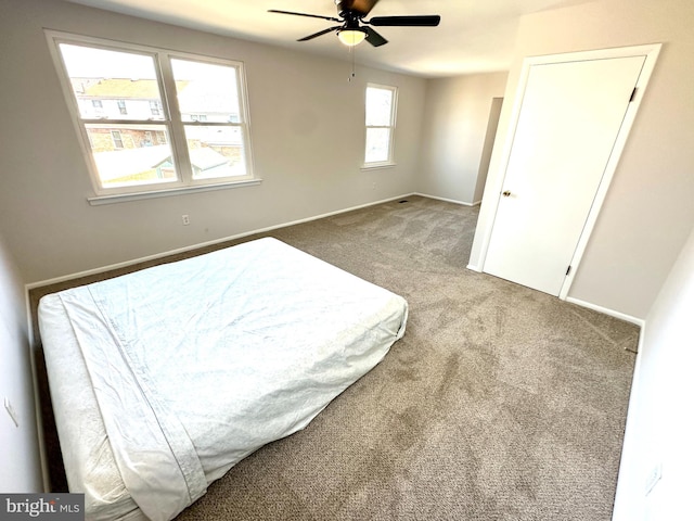 carpeted bedroom featuring a ceiling fan and baseboards