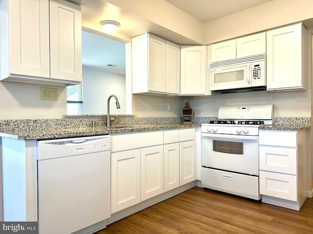 kitchen with white appliances and white cabinetry