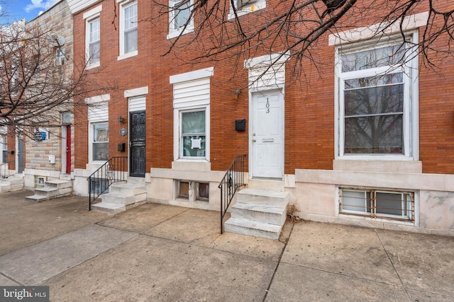 view of front of property with entry steps and brick siding