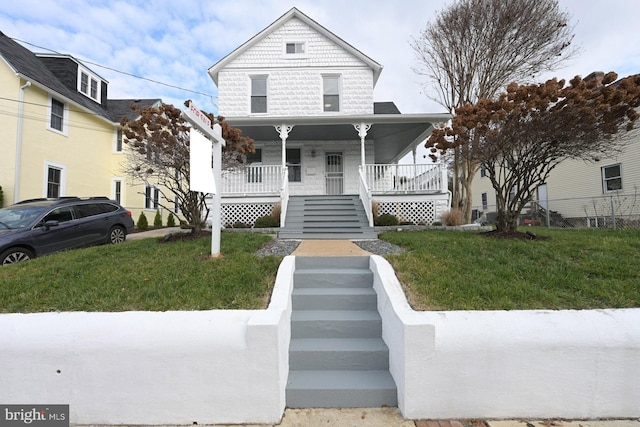 victorian house featuring stairs, a porch, and a front yard