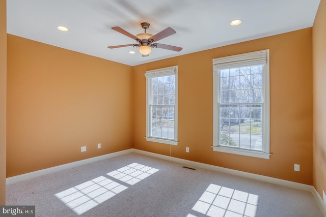 spare room with carpet floors, recessed lighting, visible vents, ceiling fan, and baseboards