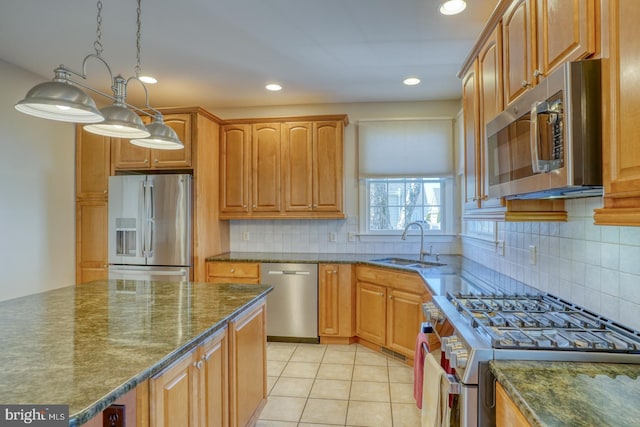 kitchen featuring tasteful backsplash, dark stone countertops, stainless steel appliances, a sink, and light tile patterned flooring