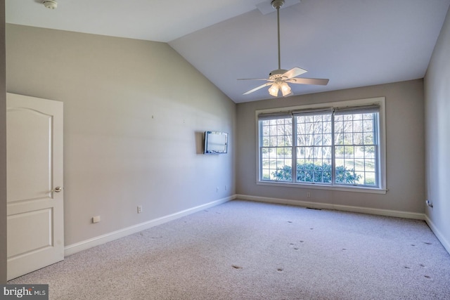 carpeted empty room featuring a ceiling fan, lofted ceiling, visible vents, and baseboards