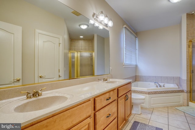 bathroom featuring double vanity, a stall shower, tile patterned flooring, and a sink