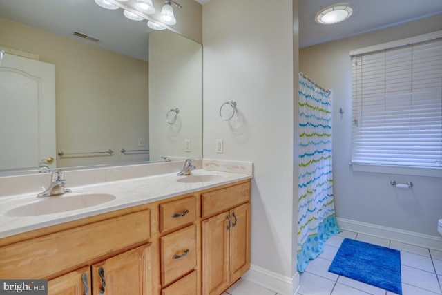 bathroom with double vanity, tile patterned flooring, a sink, and visible vents