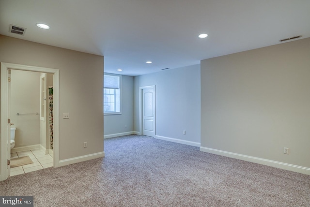 unfurnished room featuring recessed lighting, visible vents, baseboards, and light colored carpet