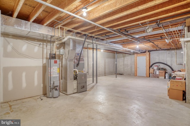 unfinished basement with gas water heater and heating unit