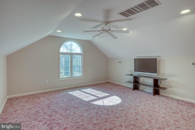 additional living space featuring baseboards, visible vents, vaulted ceiling, and carpet flooring