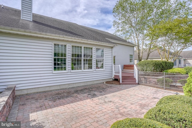 view of patio with fence and a deck