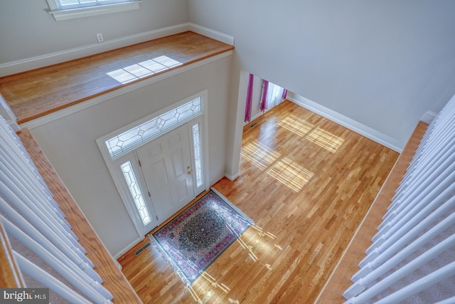 foyer with baseboards and wood finished floors