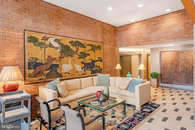 living area featuring recessed lighting and brick wall