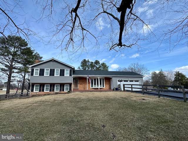 split level home with a garage, brick siding, fence, a front lawn, and a chimney