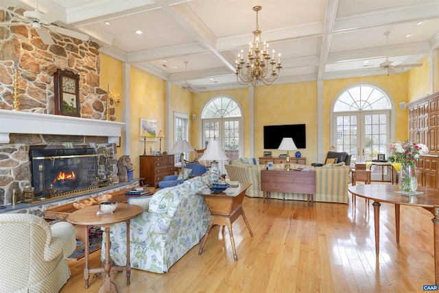 living room with beam ceiling, hardwood / wood-style flooring, a fireplace, and a ceiling fan