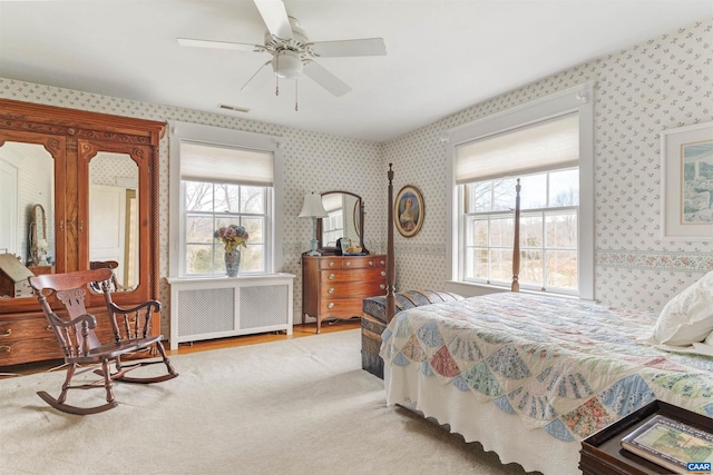 bedroom featuring radiator, visible vents, and wallpapered walls