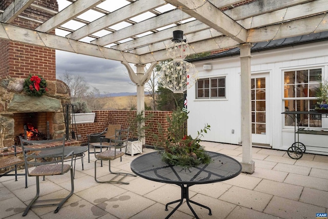 view of patio / terrace with a fireplace and a pergola