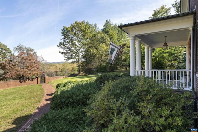 view of yard featuring covered porch