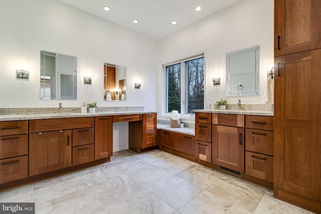 bathroom with two vanities, recessed lighting, visible vents, and a sink