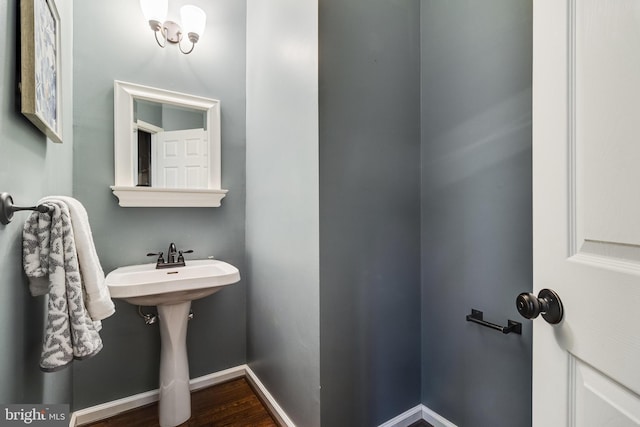 bathroom with baseboards and wood finished floors