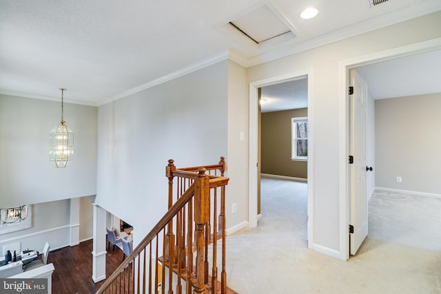 corridor featuring baseboards, crown molding, and an upstairs landing