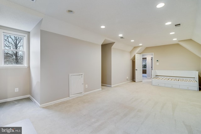 bonus room featuring lofted ceiling, recessed lighting, light carpet, visible vents, and baseboards