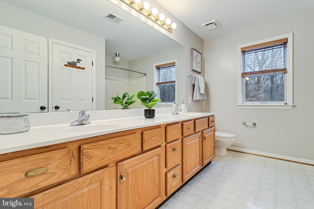 full bathroom with double vanity, a sink, visible vents, and tile patterned floors