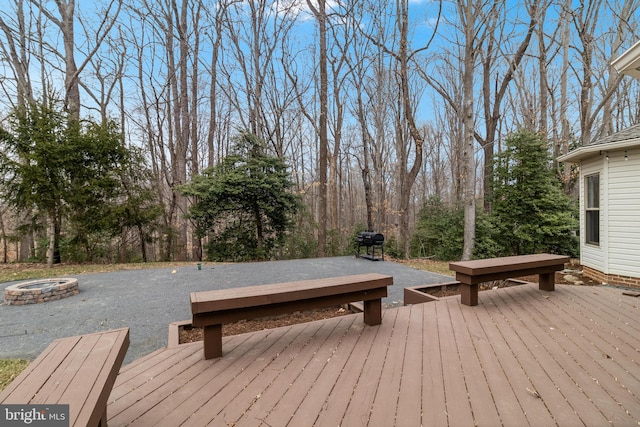 wooden deck with a fire pit