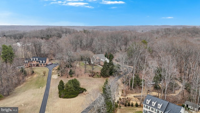 birds eye view of property with a view of trees