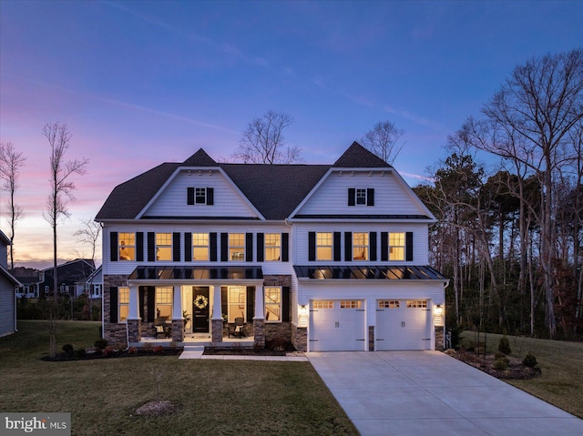 view of front facade featuring a front yard, a standing seam roof, driveway, and a gambrel roof