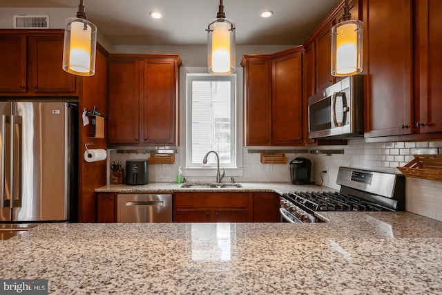 kitchen featuring visible vents, appliances with stainless steel finishes, decorative backsplash, and a sink