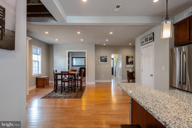 kitchen featuring light wood-style flooring, high end refrigerator, visible vents, and recessed lighting