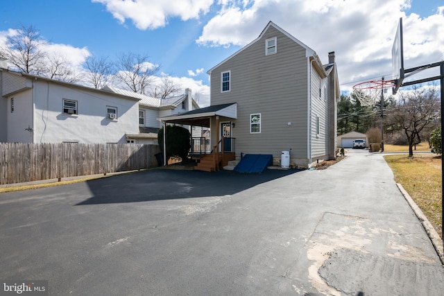 back of property with a garage and fence