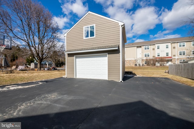 garage featuring aphalt driveway