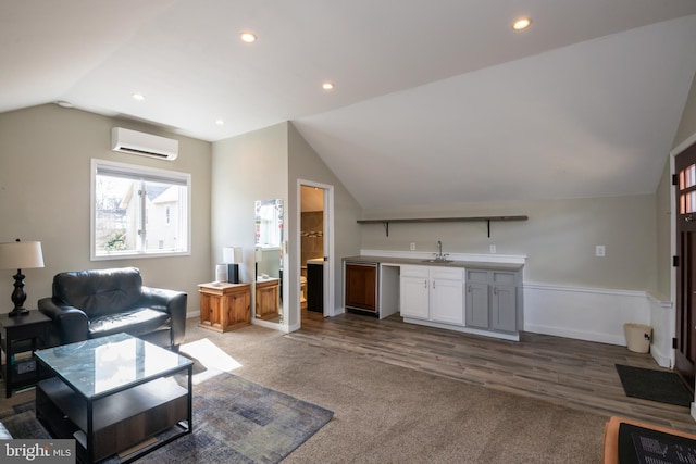 living room featuring vaulted ceiling, a wall mounted AC, recessed lighting, and baseboards