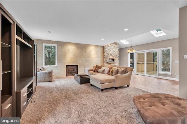 living room with a skylight, a fireplace, a wealth of natural light, and recessed lighting