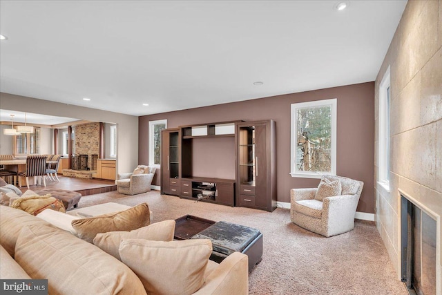 living area with recessed lighting, carpet flooring, a fireplace, and baseboards