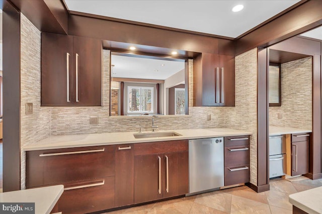 kitchen with dishwasher, light countertops, and a sink